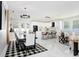 Stylish living room with adjacent dining and kitchen area featuring an open concept and sleek design at 7403 Edgemere Rd, Tampa, FL 33625
