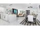 Open-concept living room with marble tile, modern lighting, and a cozy dining area at 7403 Edgemere Rd, Tampa, FL 33625