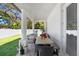 Inviting covered patio with outdoor seating, dining area, and serene backyard view at 7403 Edgemere Rd, Tampa, FL 33625