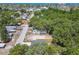 Aerial shot shows a cozy, fenced-in home tucked among lush trees in a quiet neighborhood near the ocean at 7408 Gulf Breeze Cir, Hudson, FL 34667