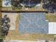 Birds eye view of a home's roof, fence, and a section of the yard; tree shadows are seen at 7408 Gulf Breeze Cir, Hudson, FL 34667