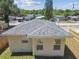 A clean view of home showing its roof, exterior paint, and newly installed wood fence at 7408 Gulf Breeze Cir, Hudson, FL 34667