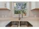 Close-up of kitchen sink with modern faucet and window providing natural light at 7408 Gulf Breeze Cir, Hudson, FL 34667