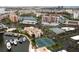 Wide aerial view of community featuring a pool, tennis courts, parking, waterway, and residences at 7910 Sun Island S Dr # 302, South Pasadena, FL 33707