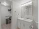 Well-lit bathroom featuring a white vanity and open access to the adjacent room at 7910 Sun Island S Dr # 302, South Pasadena, FL 33707