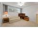 Well-lit bedroom offering a cozy sitting area with a ceiling fan and carpeted floor at 7910 Sun Island S Dr # 302, South Pasadena, FL 33707