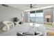 Bright living room with floor-to-ceiling windows providing water views and access to the balcony at 7910 Sun Island S Dr # 302, South Pasadena, FL 33707