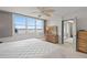 Sunlit main bedroom with large windows showcasing water views, comfortable seating, and ample storage at 7910 Sun Island S Dr # 302, South Pasadena, FL 33707