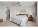 Spacious main bedroom with a large bed, neutral decor, and an ensuite bathroom at 7910 Sun Island S Dr # 302, South Pasadena, FL 33707