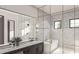 Stylish bathroom with herringbone tile, soaking tub and dual vanity with designer finishes at 8 Avonwood, Tampa, FL 33625
