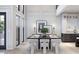 Bright dining area features high ceilings, paneled walls, and modern decor, perfect for entertaining at 8 Avonwood, Tampa, FL 33625
