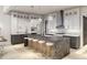 Gourmet kitchen boasts a large marble island, modern appliances, and stylish pendant lighting at 8 Avonwood, Tampa, FL 33625