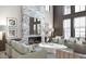 Sophisticated living room features a marble fireplace, modern furniture, and expansive windows at 8 Avonwood, Tampa, FL 33625