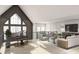 Spacious living area with high ceilings, ample natural light, and modern furnishings and piano at 8 Avonwood, Tampa, FL 33625