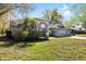 Single-story home with a three-car garage, vibrant green lawn, and appealing gray exterior at 8508 Beth Ct, Odessa, FL 33556