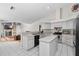 Bright kitchen featuring white tile floors, an island and a seamless transition to the living area at 8508 Beth Ct, Odessa, FL 33556