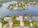 Aerial view of waterfront property showcasing its prime location, pool, and proximity to the water at 995 Eden Isle Ne Dr, St Petersburg, FL 33704