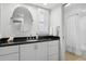 Modern bathroom with sleek vanity, round mirror, and walk-in shower, designed for relaxation and convenience at 995 Eden Isle Ne Dr, St Petersburg, FL 33704
