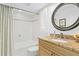 Bathroom features granite counters, a tub, and a decorative mirror at 995 Eden Isle Ne Dr, St Petersburg, FL 33704