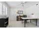 Bright bedroom features a ceiling fan, a neutral color palette, and a work desk at 995 Eden Isle Ne Dr, St Petersburg, FL 33704