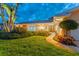 Exterior front entrance features manicured lawn, charming walkway, and inviting double doors at 995 Eden Isle Ne Dr, St Petersburg, FL 33704