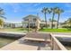 Waterfront home with a private dock, lush lawn, and views of the tranquil canal at 995 Eden Isle Ne Dr, St Petersburg, FL 33704