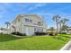 Charming waterfront home with a well-manicured lawn and a balcony overlooking the scenic waterfront at 995 Eden Isle Ne Dr, St Petersburg, FL 33704