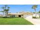 Traditional style single-story home with a well-manicured front lawn and an attached two-car garage at 995 Eden Isle Ne Dr, St Petersburg, FL 33704