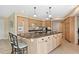 Bright kitchen featuring a large island with granite countertops and wood cabinetry at 995 Eden Isle Ne Dr, St Petersburg, FL 33704