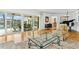 Living room boasts hardwood floors and sliding glass doors that open to a tranquil outdoor patio at 995 Eden Isle Ne Dr, St Petersburg, FL 33704