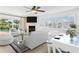 Living room with fireplace, comfortable seating, and lots of natural light at 995 Eden Isle Ne Dr, St Petersburg, FL 33704
