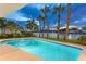 Private pool offers a serene escape, enhanced by swaying palm trees, clear water, and views of the intercoastal at 995 Eden Isle Ne Dr, St Petersburg, FL 33704