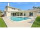 Backyard pool with patio, ceiling fans, and ample space for relaxing and entertaining at 995 Eden Isle Ne Dr, St Petersburg, FL 33704