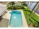 Refreshing pool in a tropical backyard, surrounded by lush greenery and swaying palm trees at 995 Eden Isle Ne Dr, St Petersburg, FL 33704
