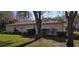 Rear exterior view of property showing the lush lawn, mature trees, and manicured landscaping at 9131 Woodridge Run Dr, Tampa, FL 33647