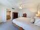 Spacious bedroom with carpet flooring, a ceiling fan and access to a bathroom at 105 4 Ne # 501, St Petersburg, FL 33701