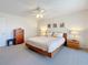 Cozy bedroom with a ceiling fan, carpet floors, and matching bedside tables at 105 4Th Ne Ave # 501, St Petersburg, FL 33701