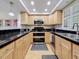 Galley kitchen with stainless steel appliances, tiled countertops, and ample cabinet space at 105 4Th Ne Ave # 501, St Petersburg, FL 33701