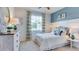 Inviting bedroom with a comfortable bed, stylish dresser, and large window for natural light at 10523 Farm Hill Ave, Land O Lakes, FL 34638