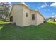 A view of the exterior of the home and green grass at 11321 Copley Ct, Spring Hill, FL 34609