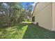 A view of the exterior of the home and green grass at 11321 Copley Ct, Spring Hill, FL 34609