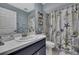 Bathroom featuring a nautical theme, vanity, and tiled shower-tub combination at 11321 Copley Ct, Spring Hill, FL 34609