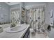 Bright bathroom with a nautical theme, vanity with mirror, and tiled shower-tub combination at 11321 Copley Ct, Spring Hill, FL 34609