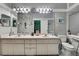Spacious bathroom featuring double sinks, a large mirror, and stylish fixtures at 11321 Copley Ct, Spring Hill, FL 34609