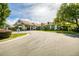 A long driveway that leads to the exterior of this beautifully landscaped building at 11321 Copley Ct, Spring Hill, FL 34609