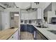 Bright kitchen boasts stainless steel appliances, tile backsplash, and modern two-tone cabinetry at 11321 Copley Ct, Spring Hill, FL 34609