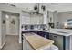 Charming kitchen featuring butcher block island, modern appliances, and stylish two-tone cabinetry at 11321 Copley Ct, Spring Hill, FL 34609