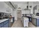 Stylish kitchen with a center island, white cabinets, stainless steel appliances and modern backsplash at 11321 Copley Ct, Spring Hill, FL 34609