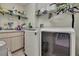 Efficient laundry room with modern washer and dryer and shelving at 11321 Copley Ct, Spring Hill, FL 34609