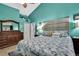 Serene main bedroom with a coastal theme, complemented by a large dresser and calming colors at 11321 Copley Ct, Spring Hill, FL 34609